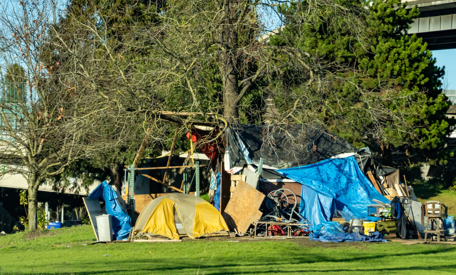 A homeless people camp at the base of a bridge over the Willamette River in Portland Oregon