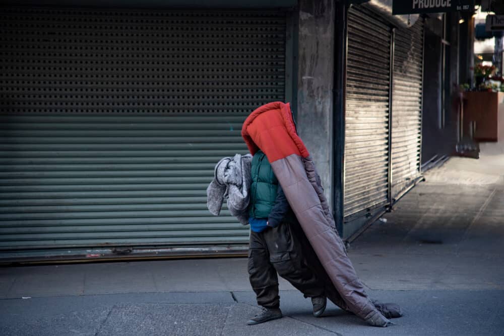 Homeless Man Wearing a Sleeping Bag