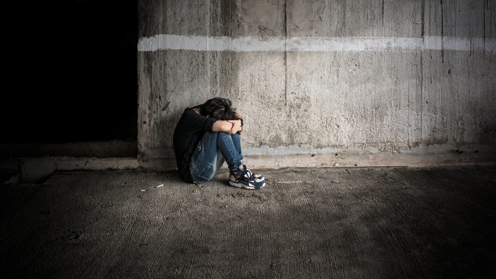 Light still shine even in the moment of despair , a girl facing down alone in abandoned building in Low key photo