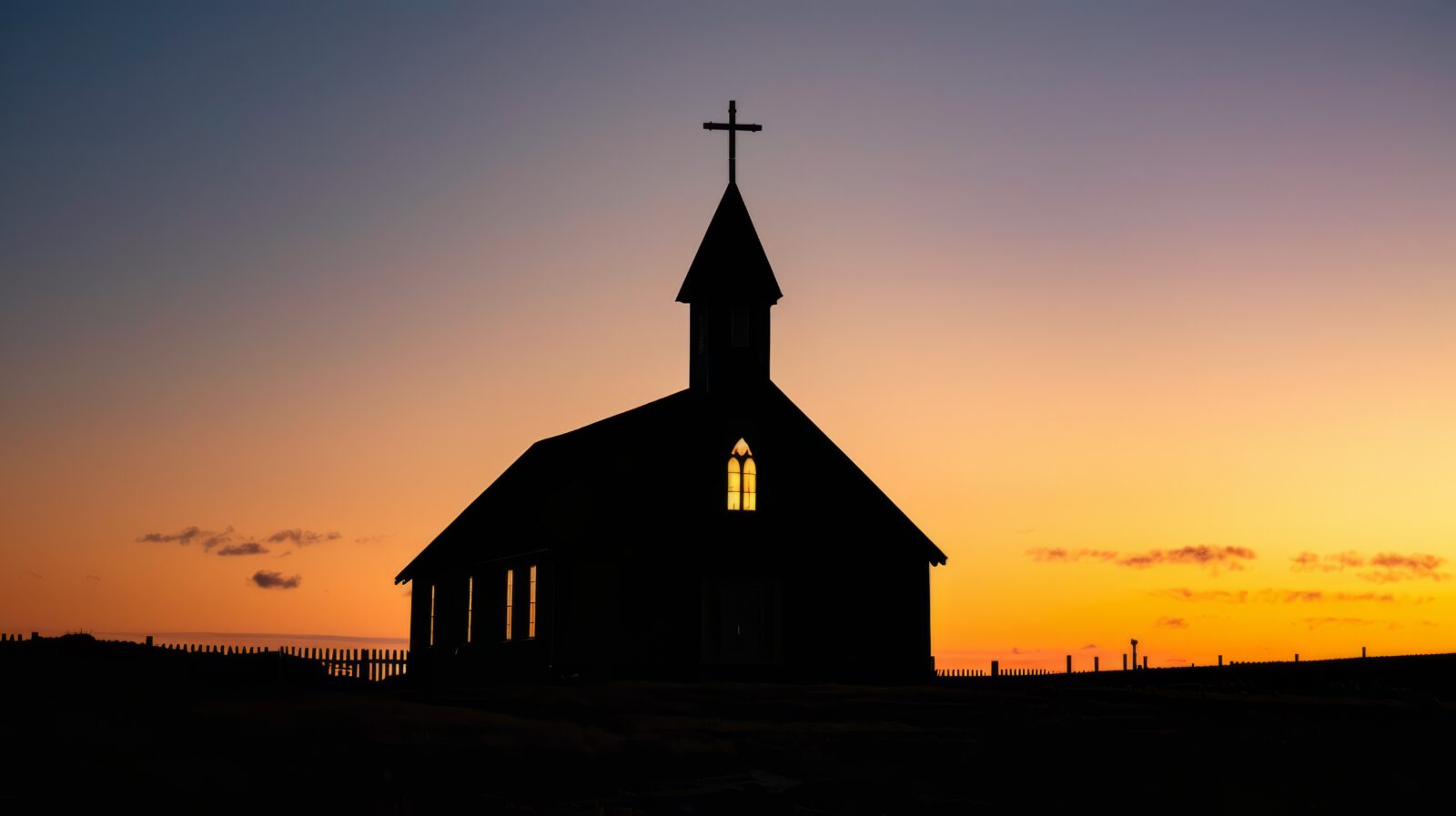 Simple silhouette of a church building with a cross on top, conveying the essence of Christian worship